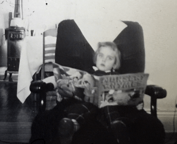 child reading a large book