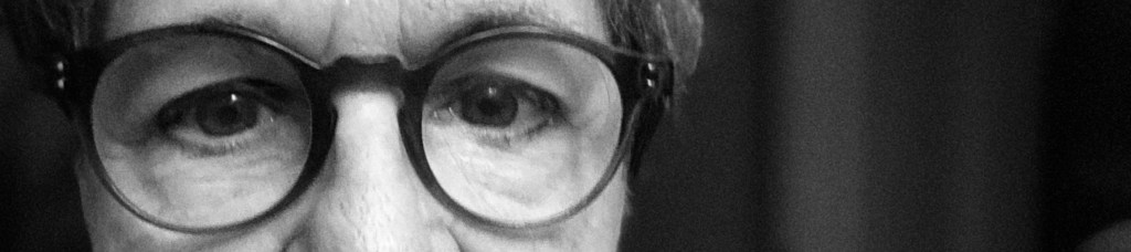 Woman wearing glasses, looking.