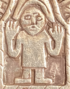a carving of a confused human