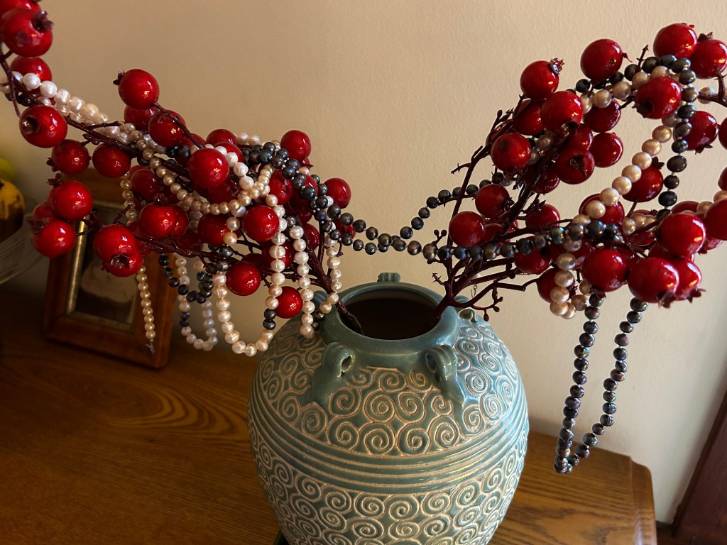 Unmatched pearls on red berry branches