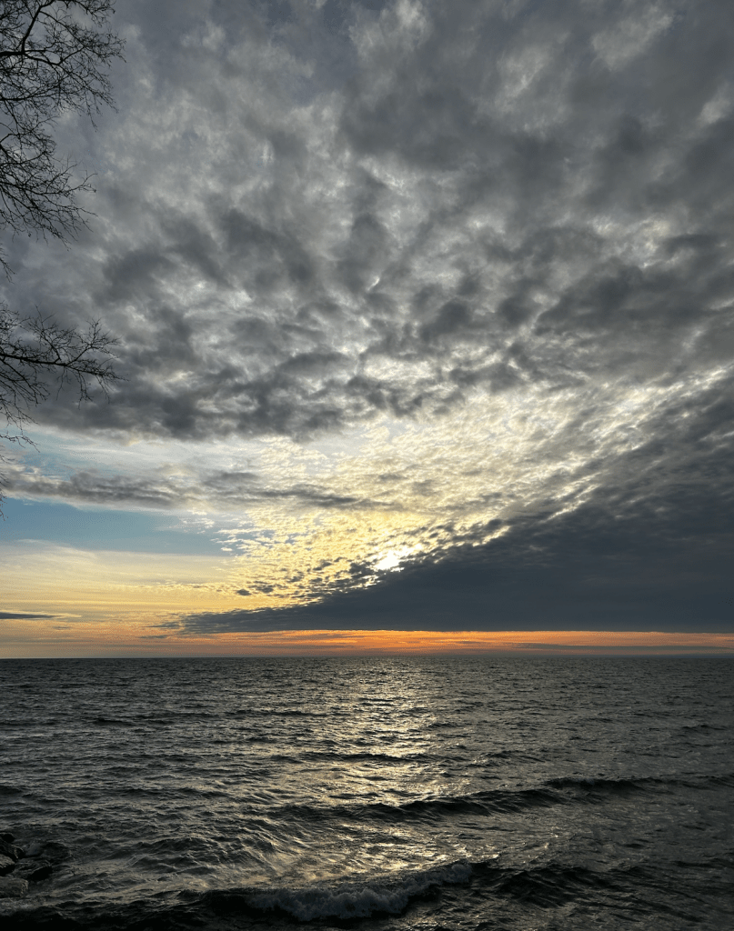 Dark clouds, sunrise, and lake