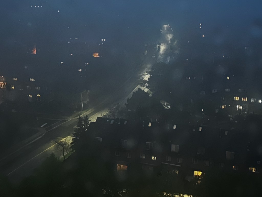 Some headlights in a twisting path at night