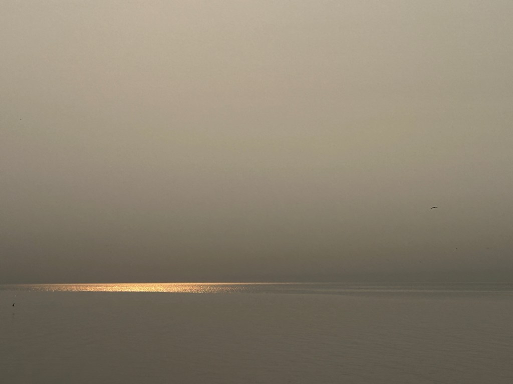 Early morning -a sliver of sun reflection on the lake