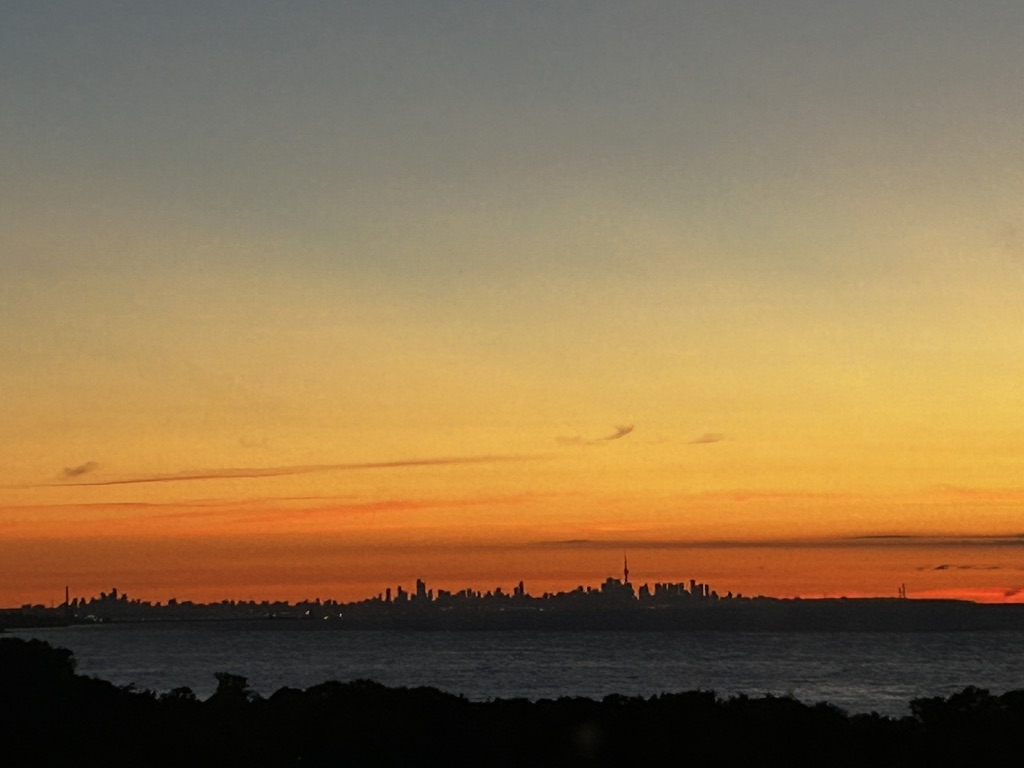 Sunrise behind the horizon's silhouette.